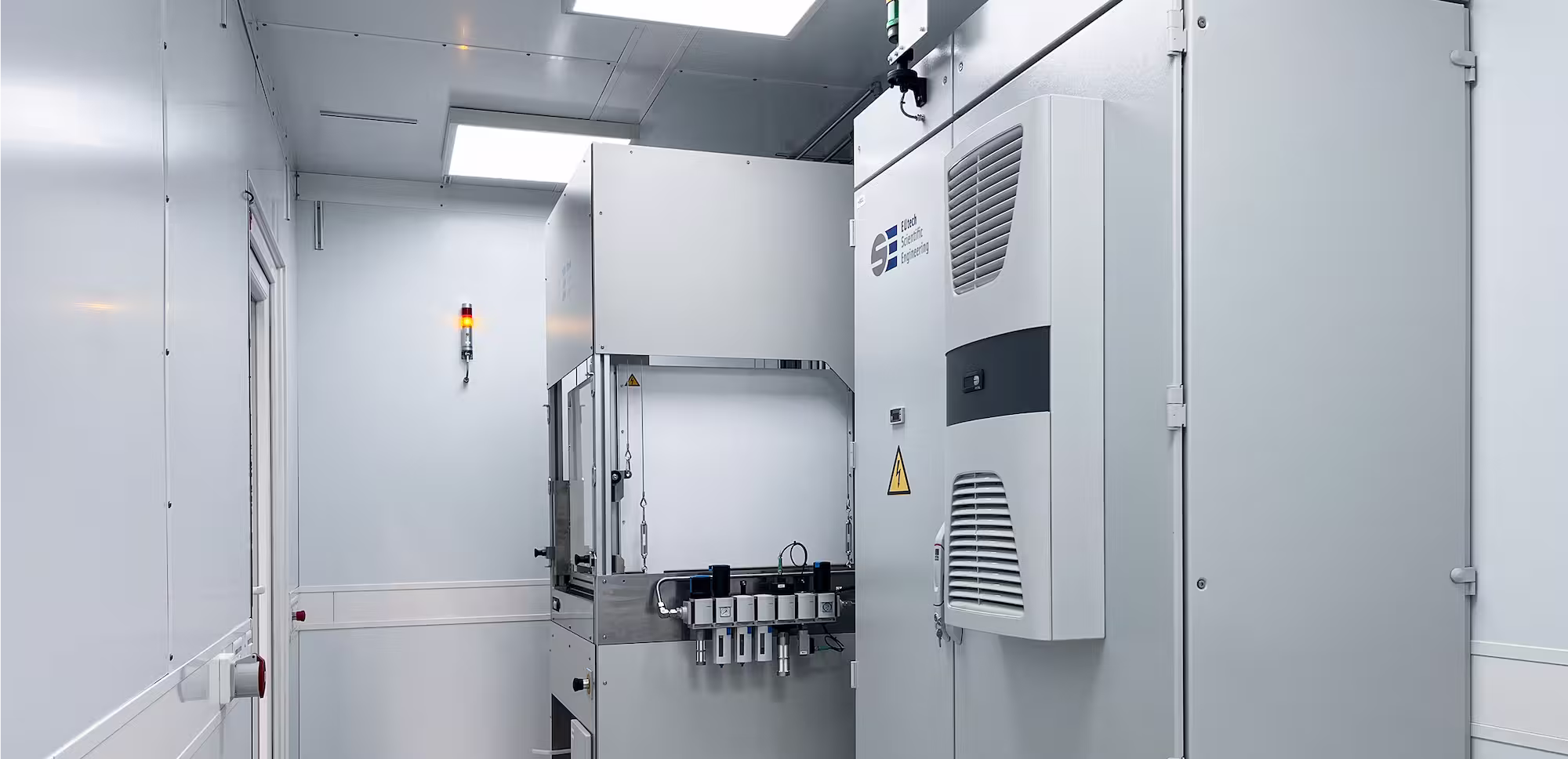 Clean, white industrial container room housing a hydrogen and fuel cell test bench.