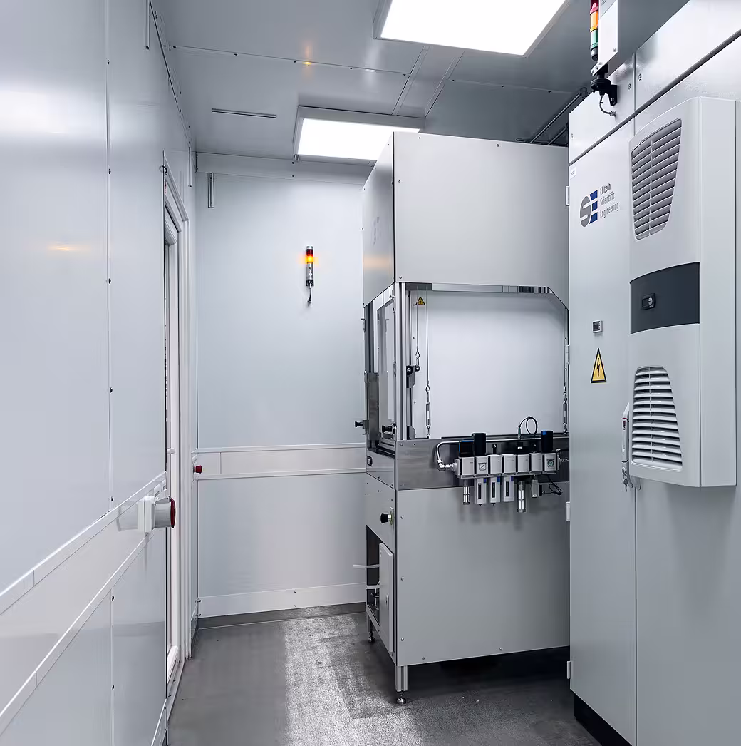 Clean, white industrial container room housing a hydrogen and fuel cell test bench