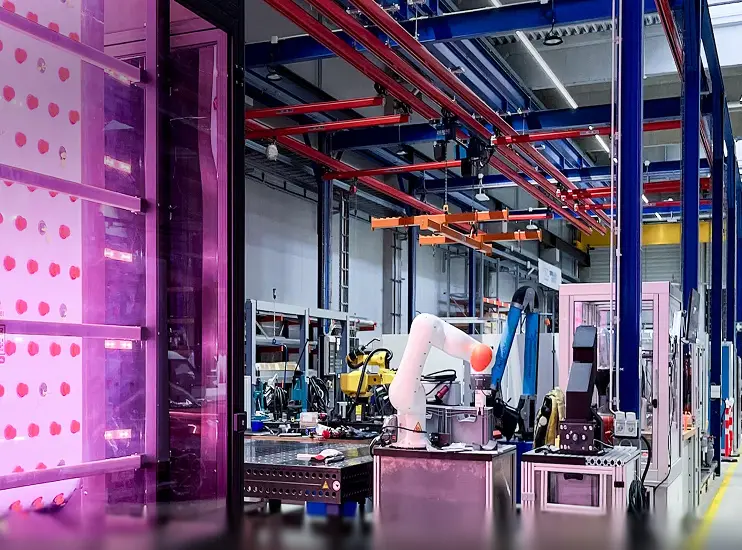 Vertical Farm inside a factory with machinery and equipment.