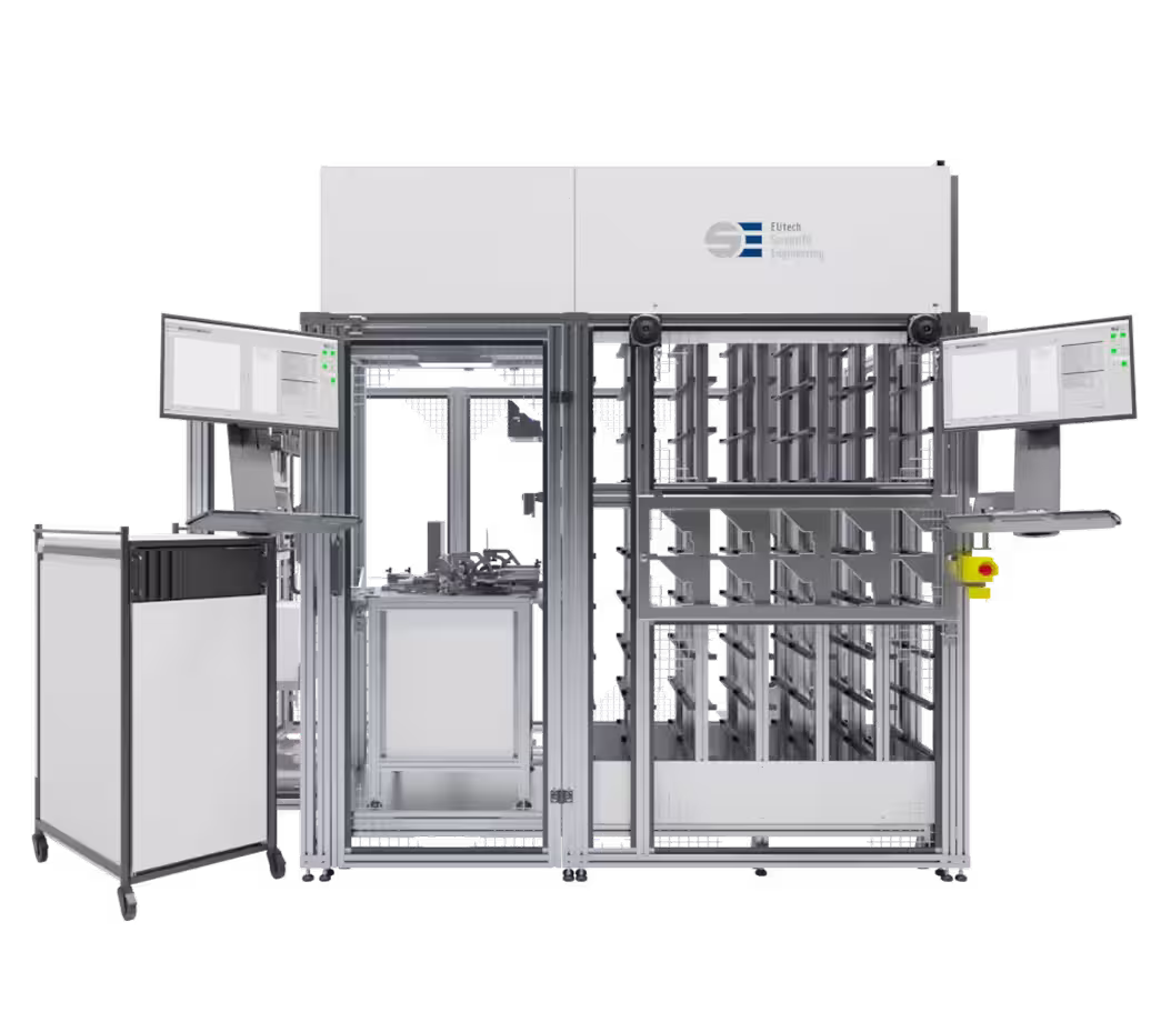 Large industrial tyle handler with dual monitors, metal frame, and storage racks.