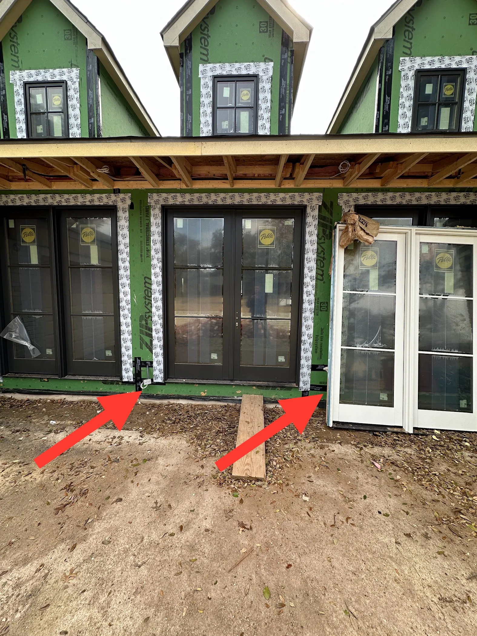 New French doors and windows installed in sheathed wall