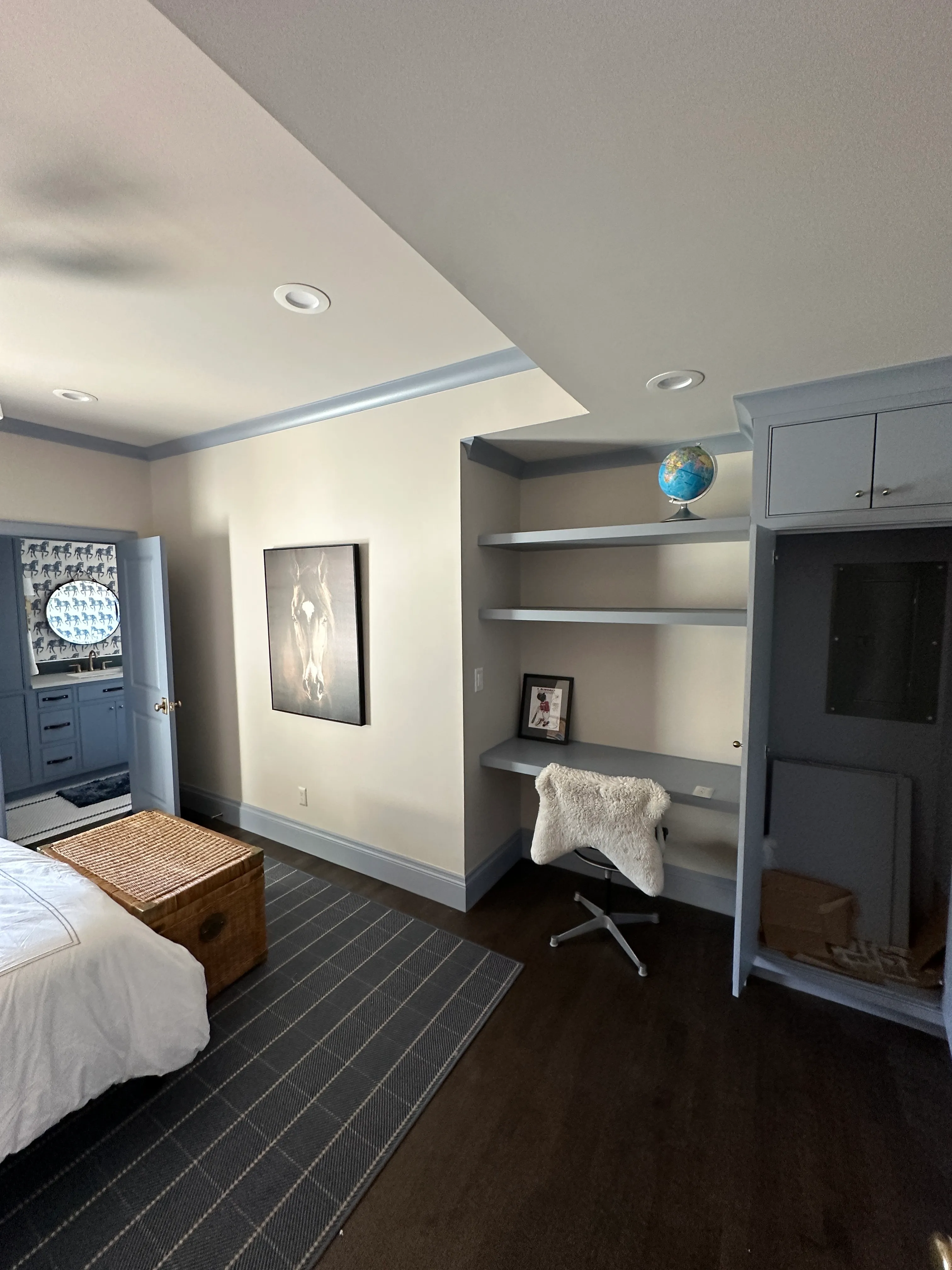 Bedroom with built-in shelving and desk