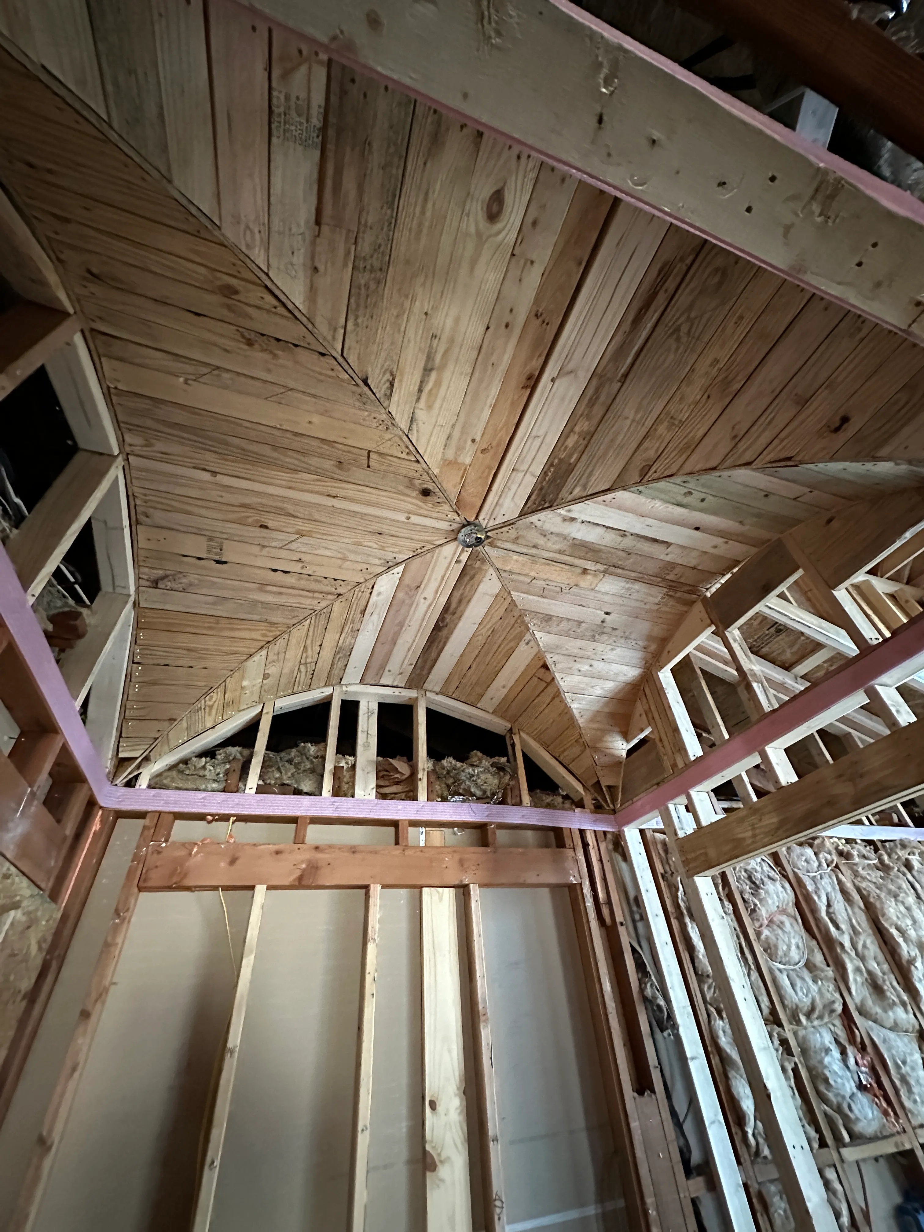 Custom wood-plank ceiling detail in framing stage