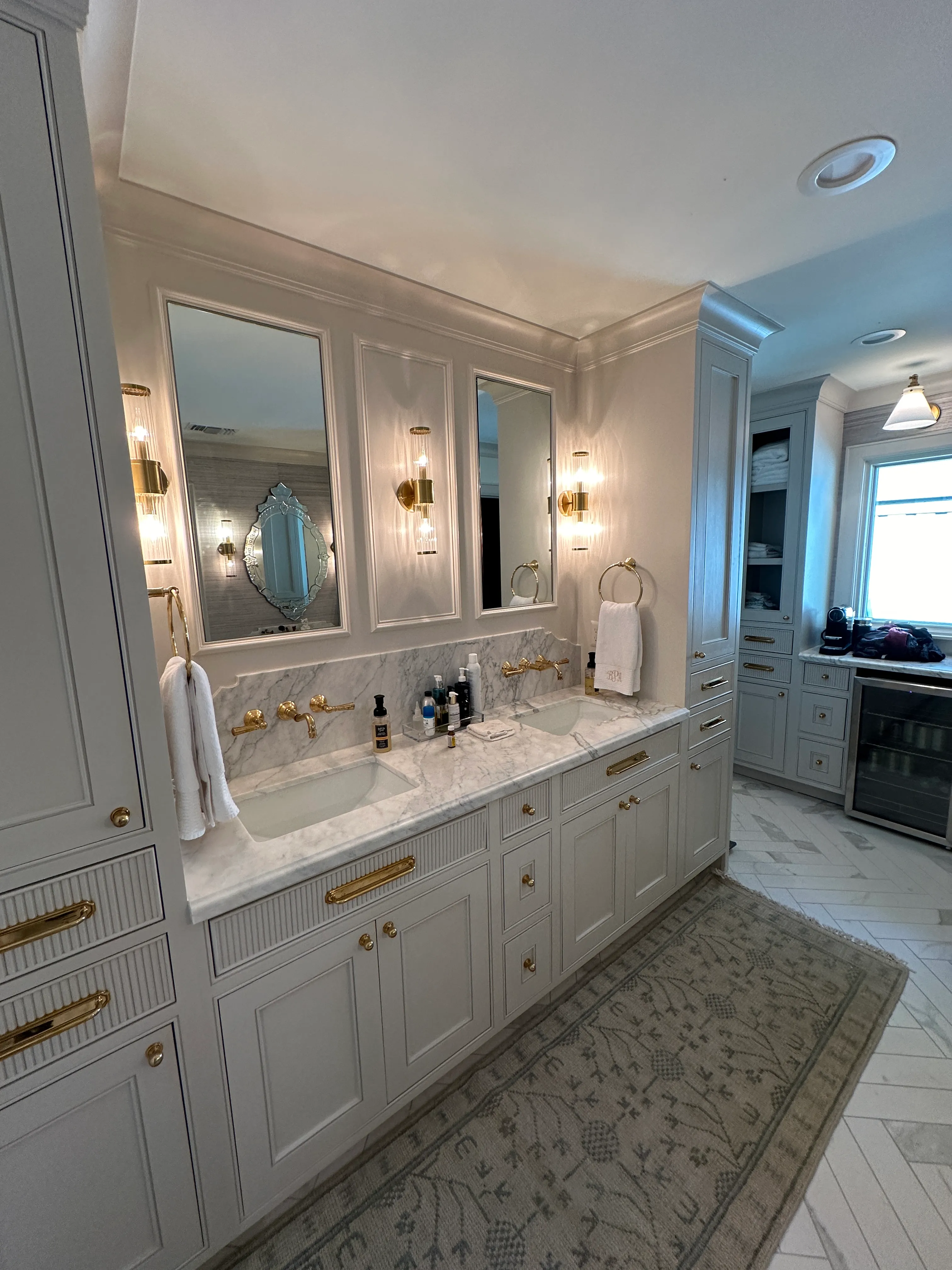 Primary bath double vanity with custom mirrors and brass hardware
