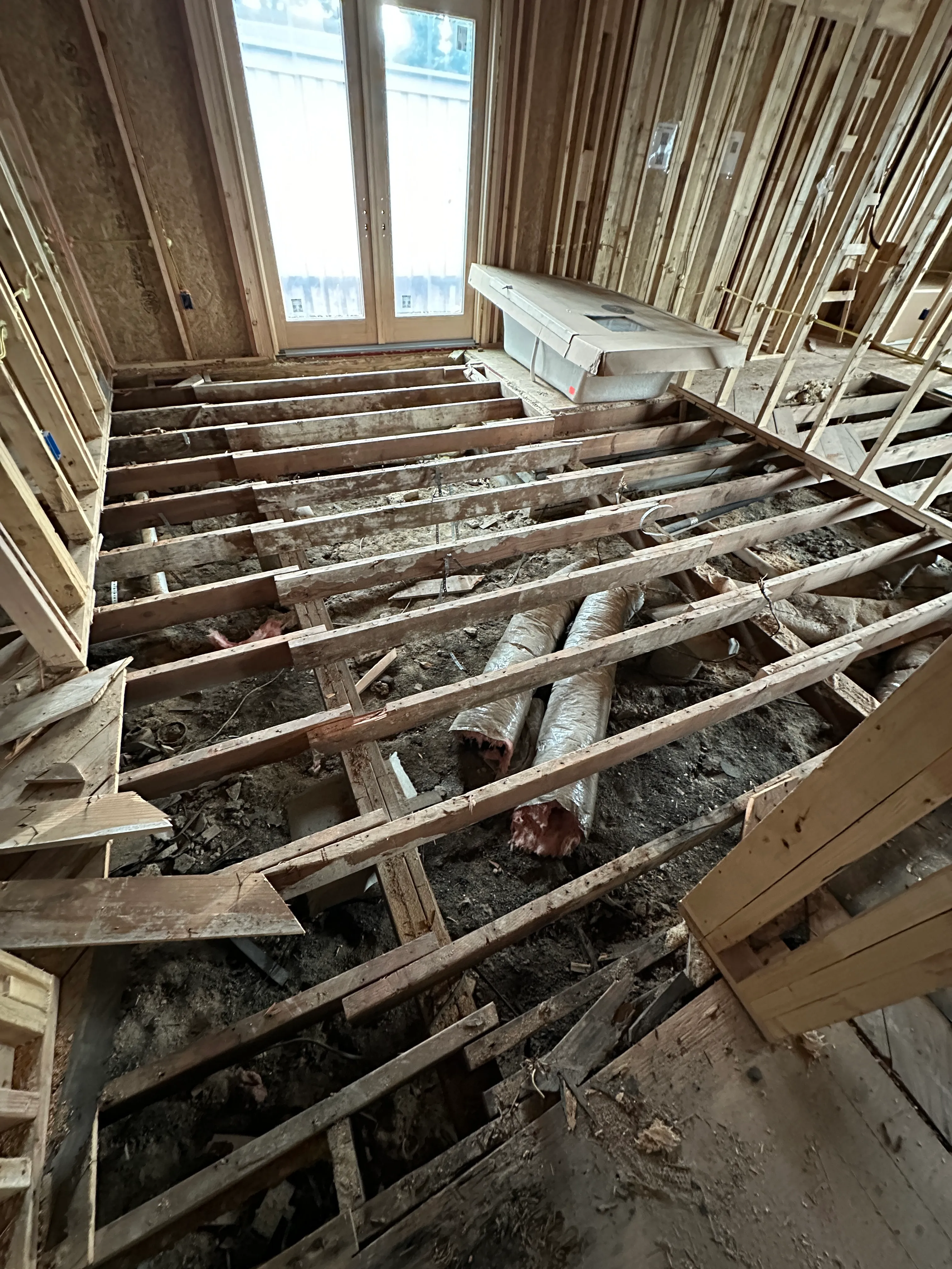 Pier and beam foundation work beside new framing