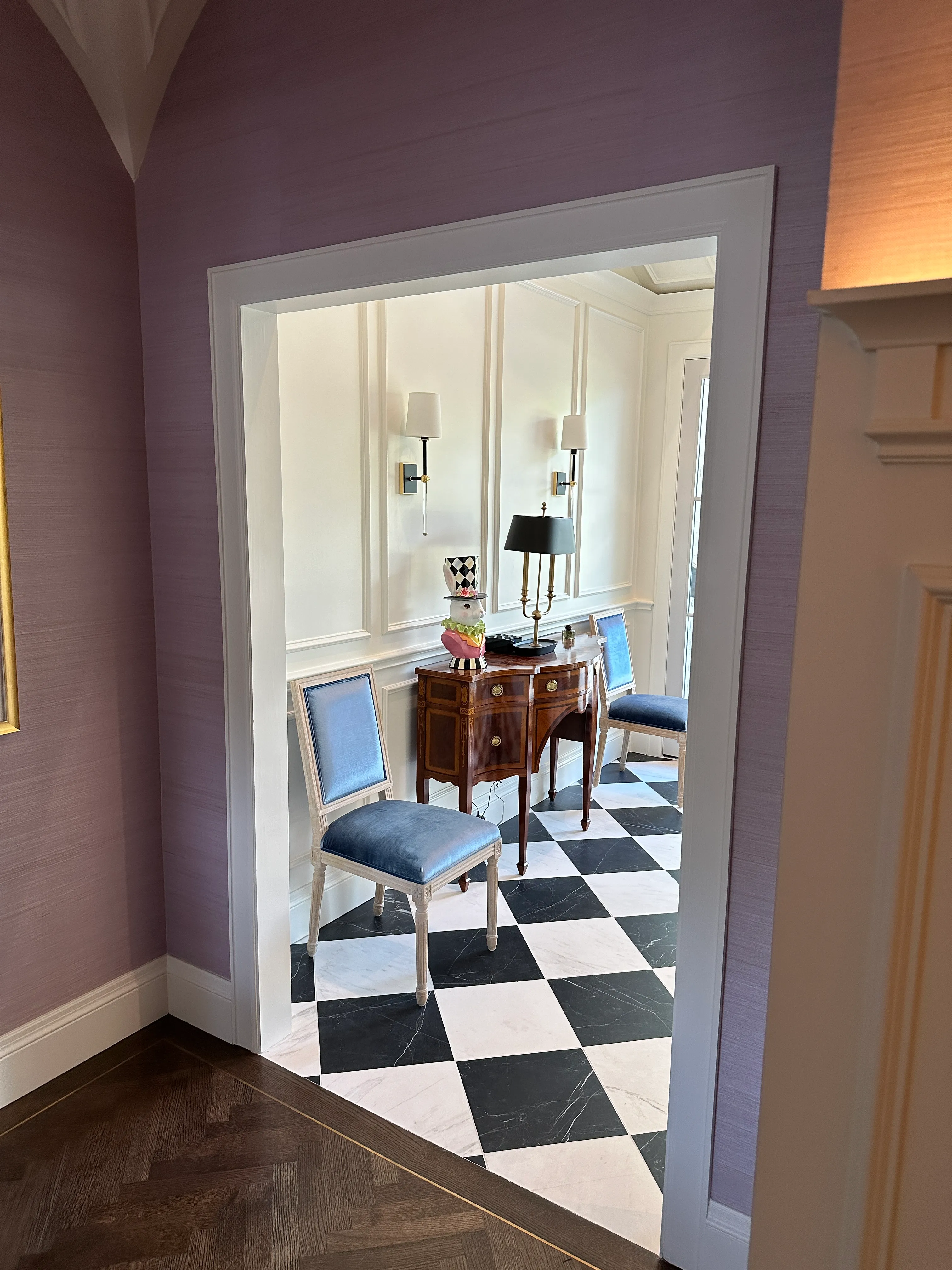 Hallway niche with console and checkerboard floor