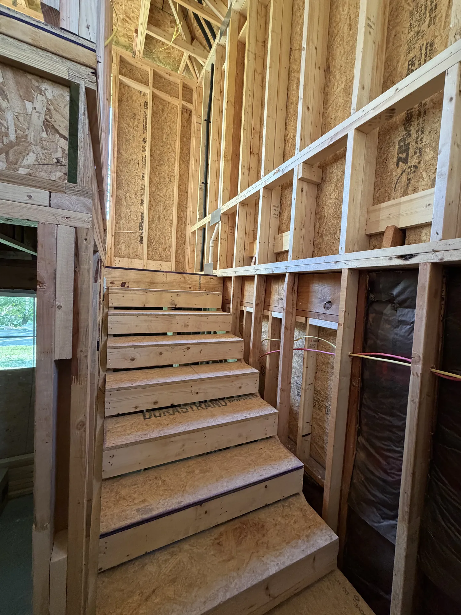 Framed staircase with landing and guard wall framing