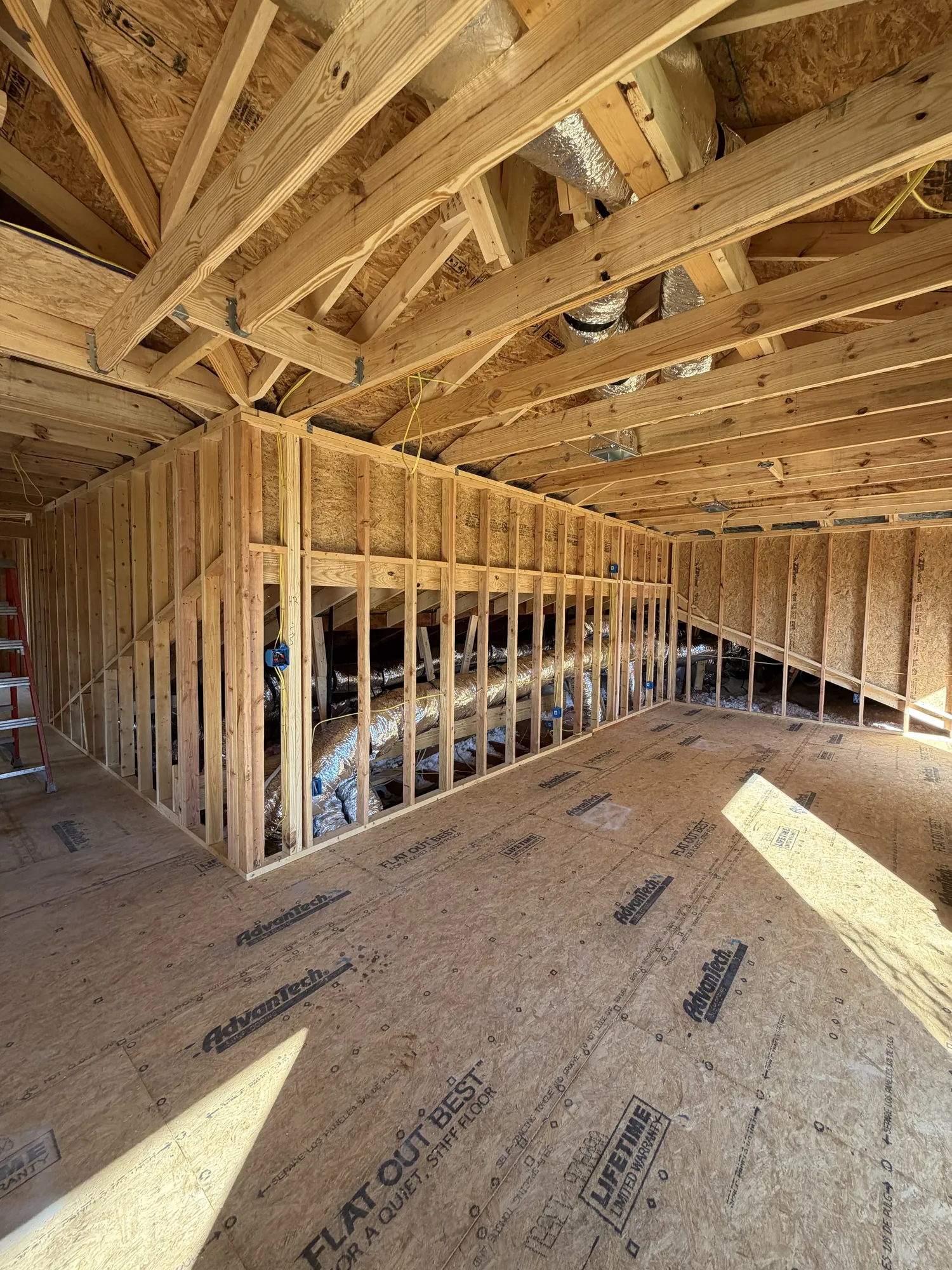 Second-floor room framed with knee walls and HVAC ducts running through the attic space