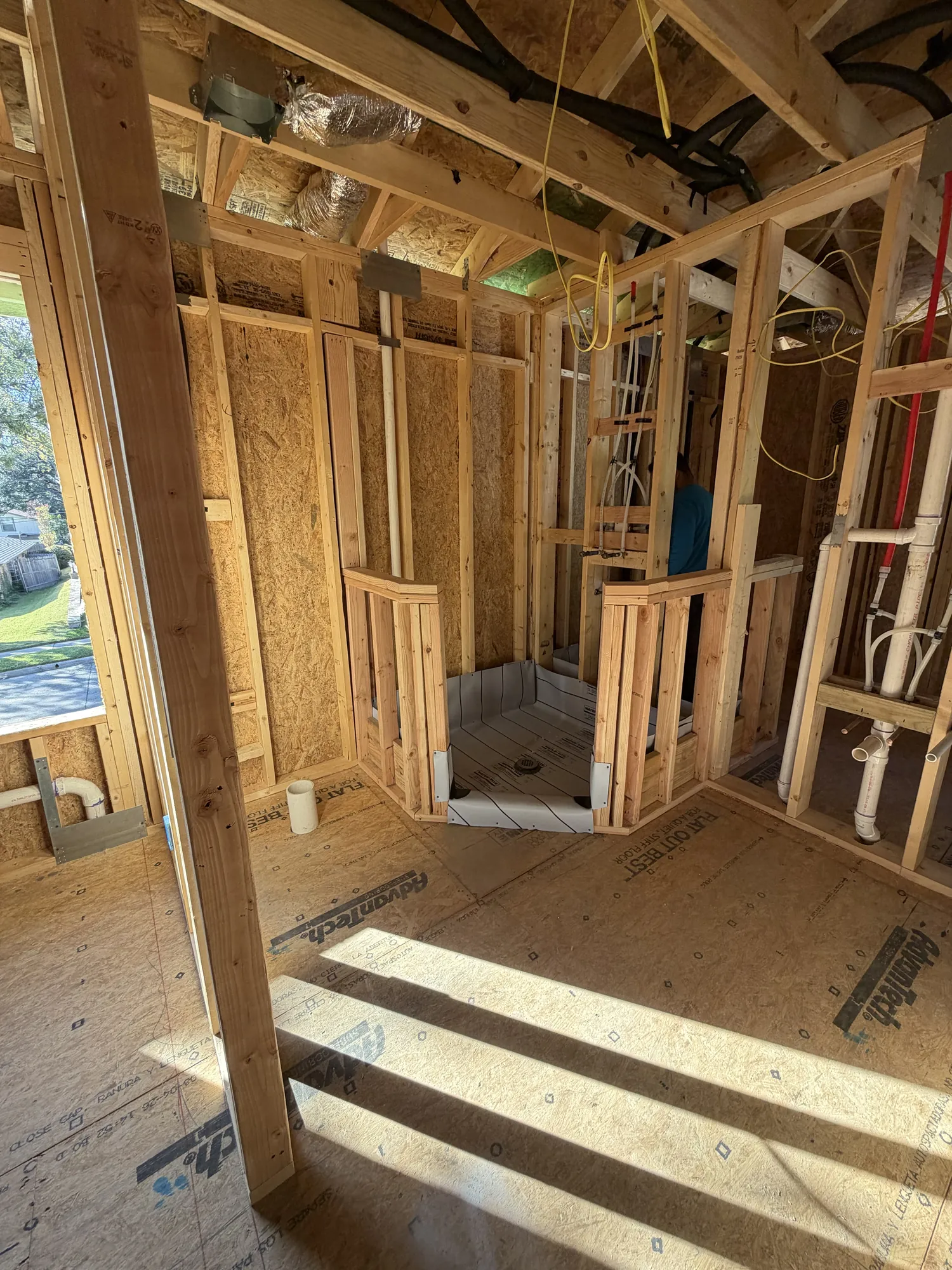 Framed shower area with plumbing drain rough-in in the second-floor bathroom