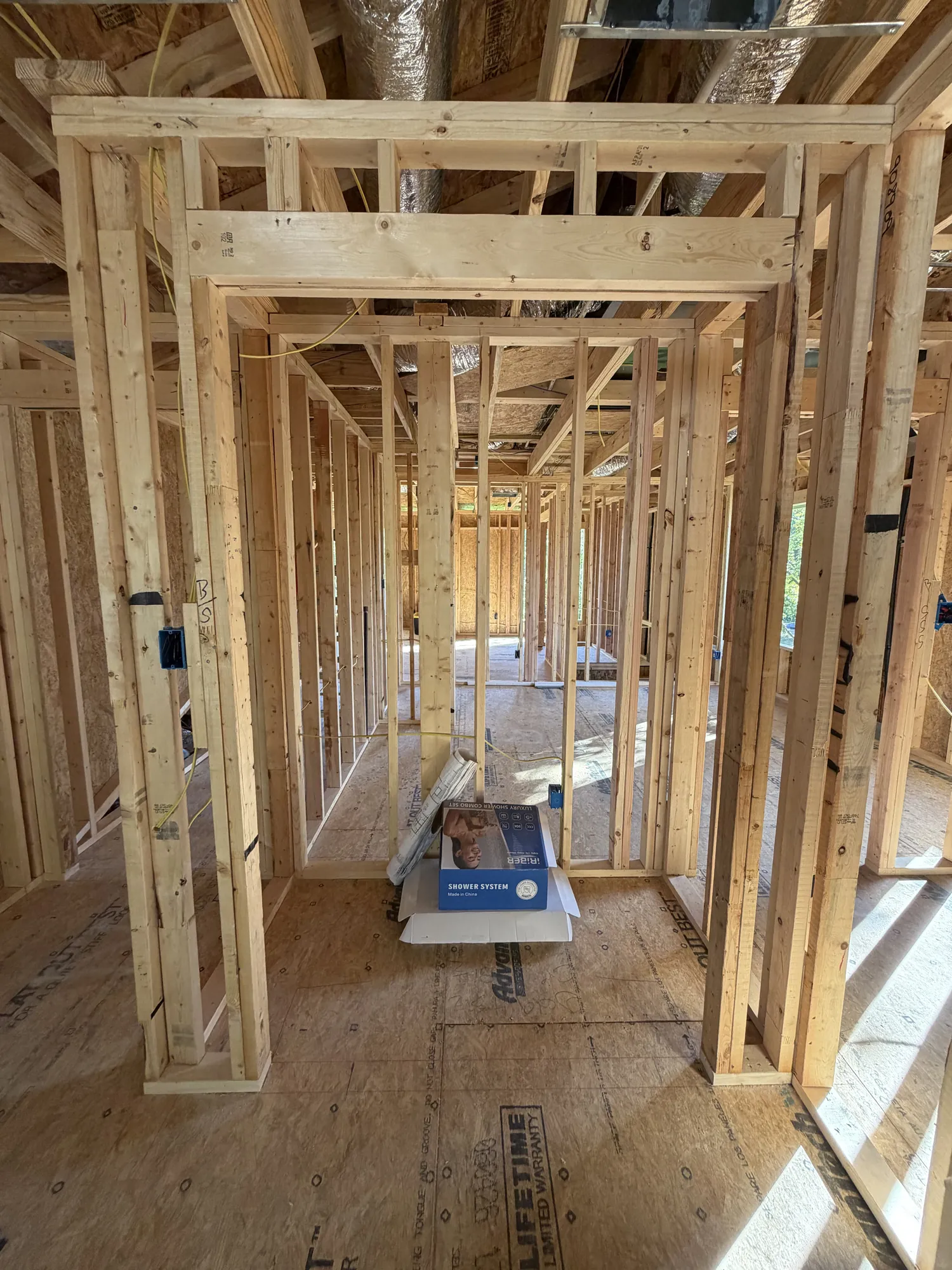 Second-floor hallway framed with door openings and ductwork overhead