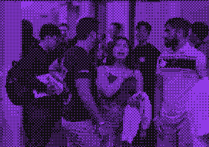 Group of people socializing indoors, some holding drinks and one person carrying a backpack.