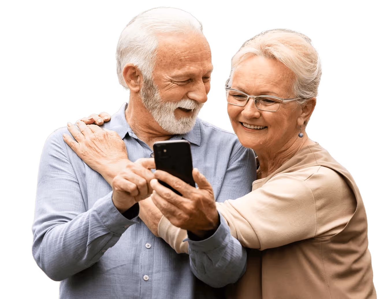 Smiling elderly couple looking at a smartphone, woman hugging man from behind.