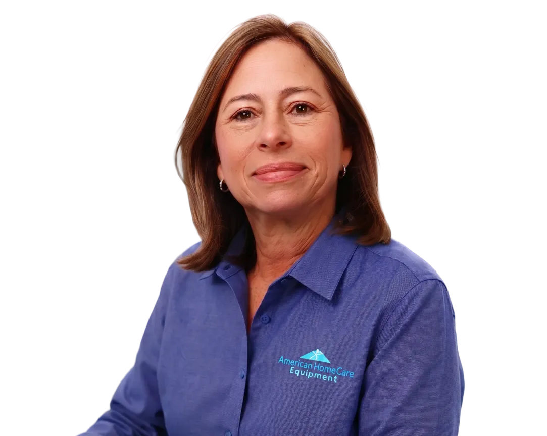 Woman in a blue shirt with American HomeCare Equipment logo smiling at the camera.