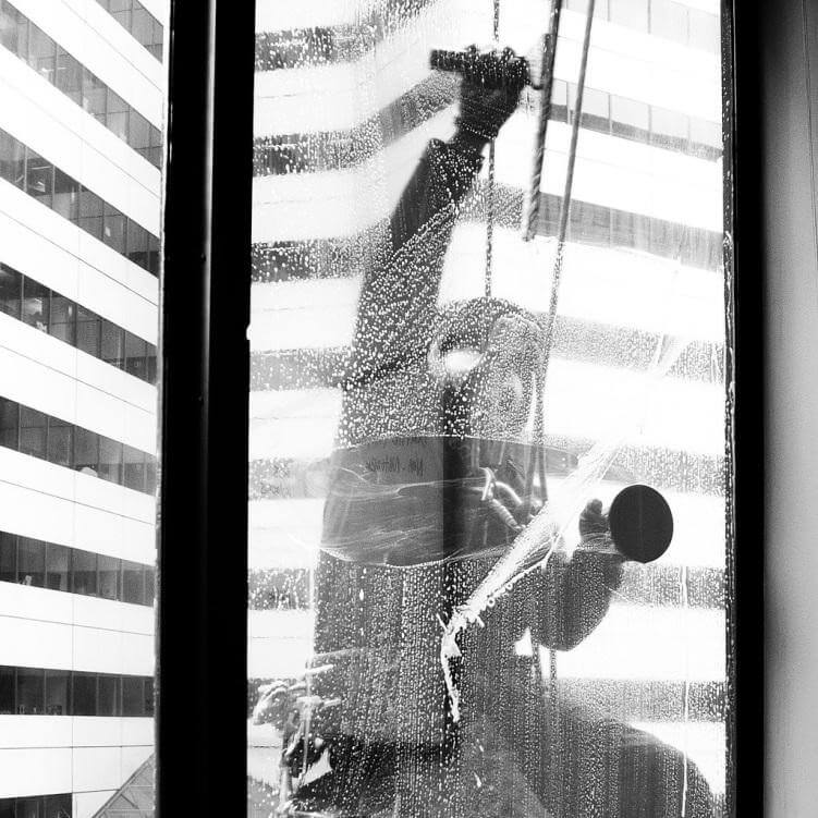 How do professional window washers clean windows?