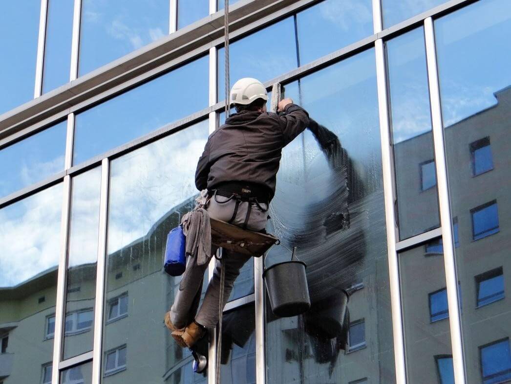 How do professional window washers clean windows?