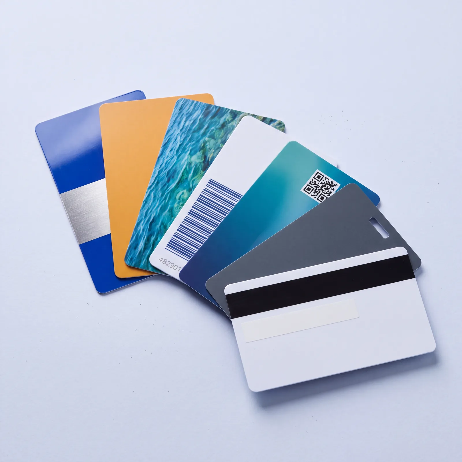 A fan of gloss blue membership cards with a gold band, one turned over to show the magnetic stripe