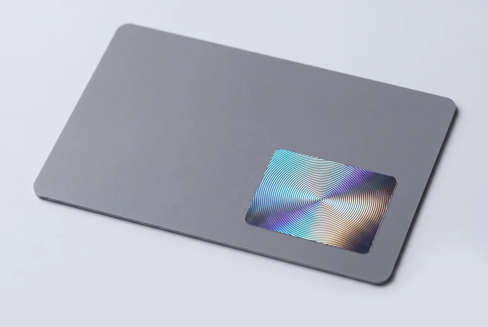Grey card with a rectangular holographic patch showing concentric rings