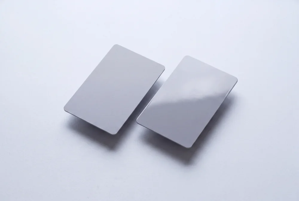 Two grey cards side by side comparing a matte and a glossy surface