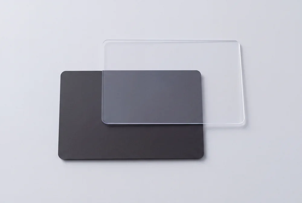 Clear transparent card overlapping a black card, which shows through it