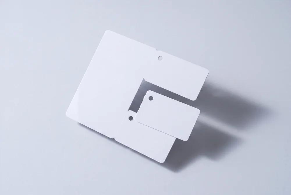 Card sheet with three shapes partly broken out along their micro tabs
