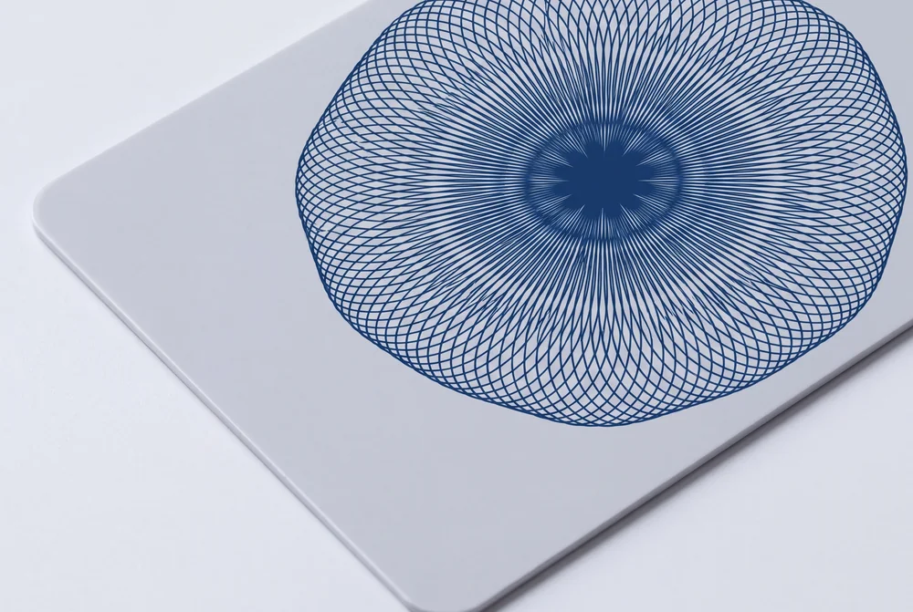 Close-up of a fine blue guilloche line pattern printed on a white card