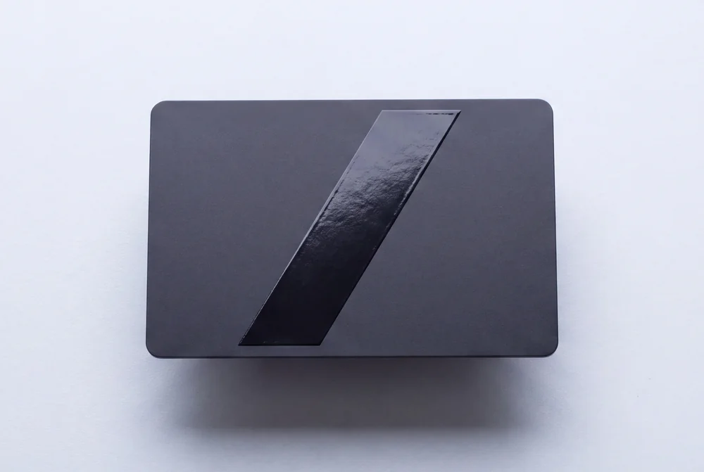 Matte black card with a diagonal band of high gloss spot varnish