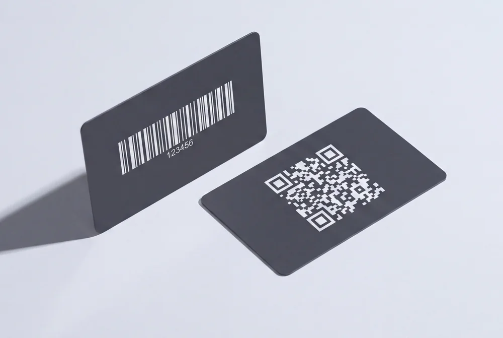 Two dark cards, one printed with a barcode and one with a QR code