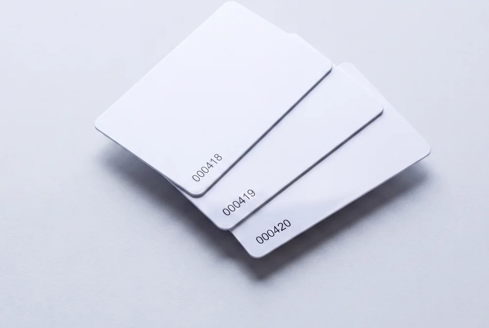 Three white cards fanned out, each printed with a different sequential number