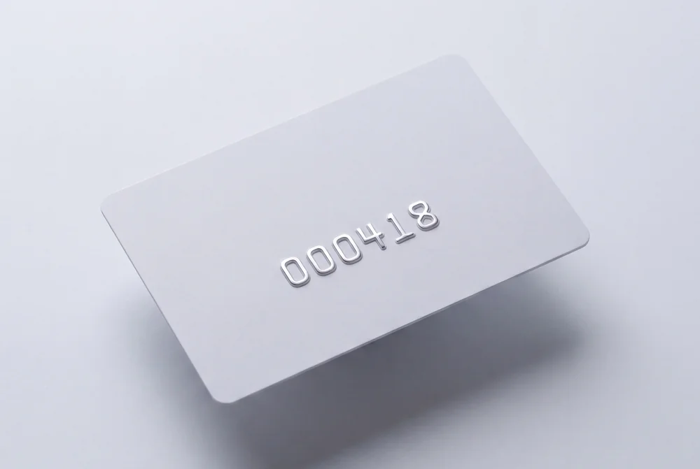 White card with a number in raised embossed characters catching the light