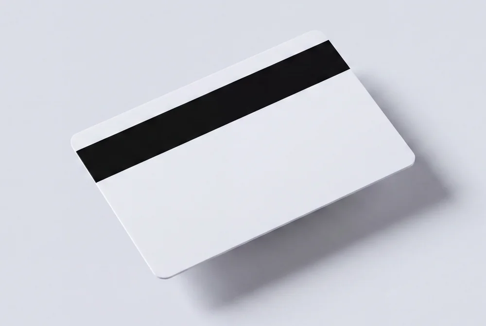 White card seen from the back with a black magnetic stripe running across it