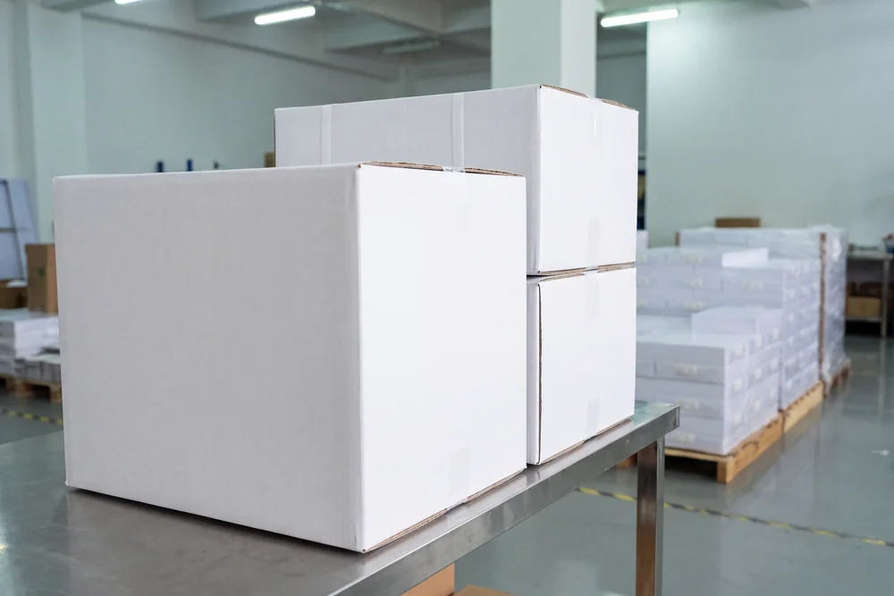 Two plain white shipping cartons with no printing, logo or label of any kind
