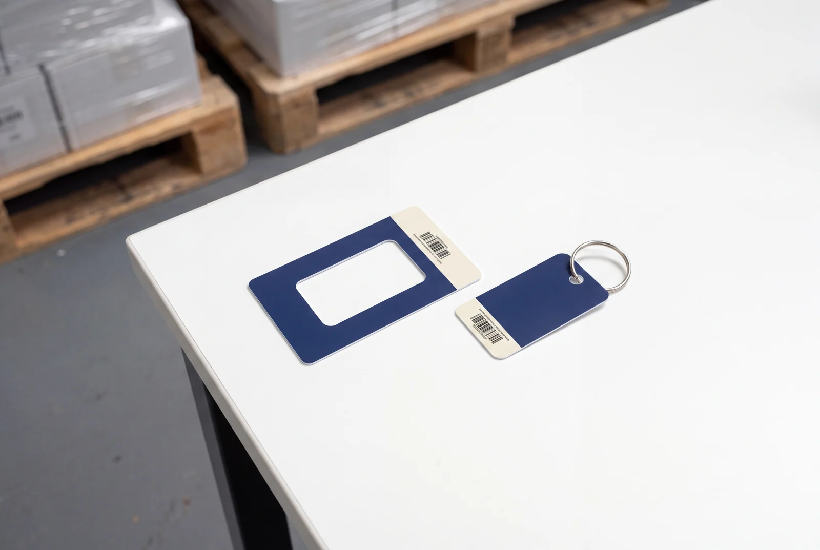 A navy card with the key tag punched out of it, and the tag beside it on a split ring