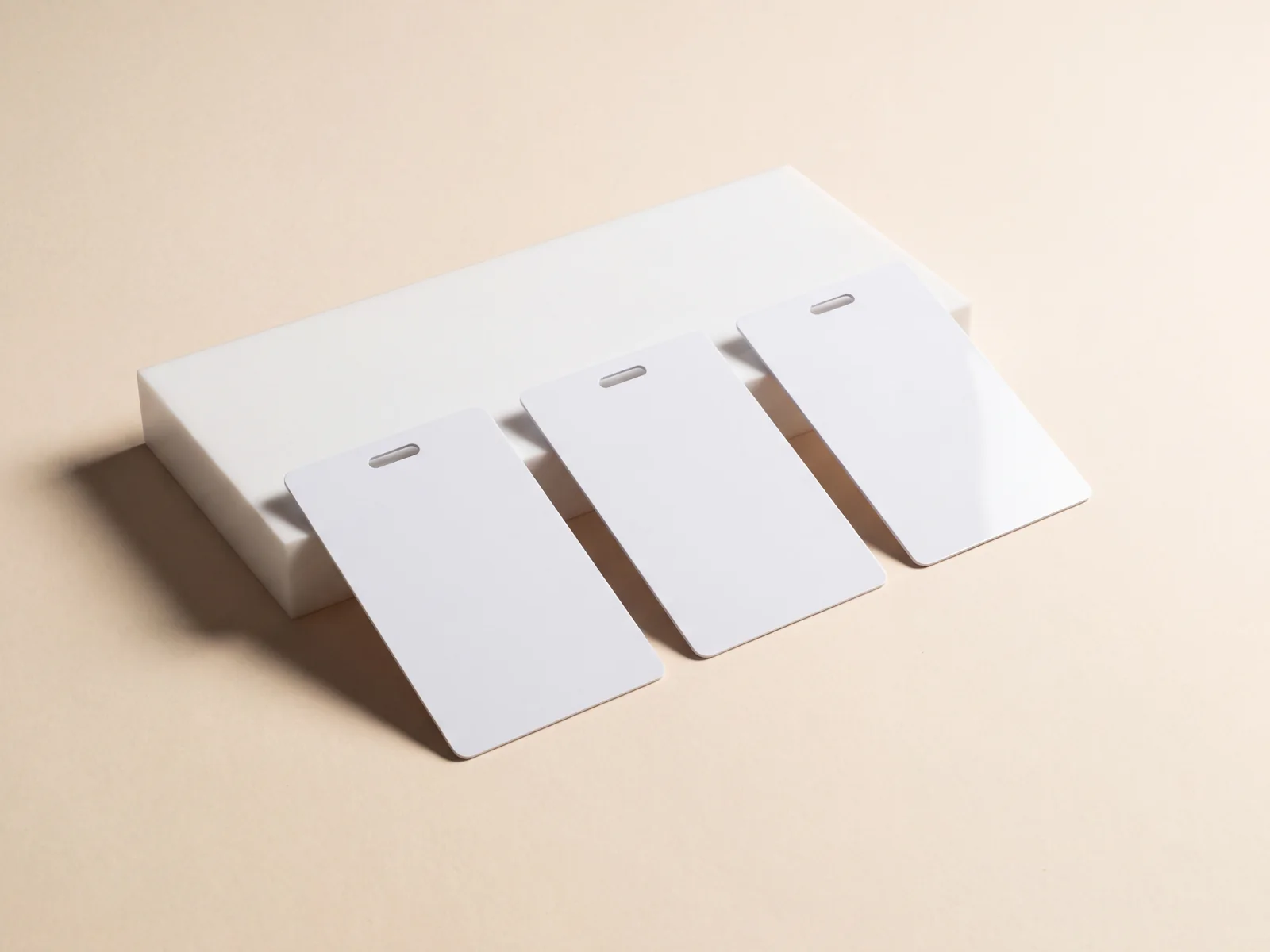 Three blank staff credential cards with a lanyard slot