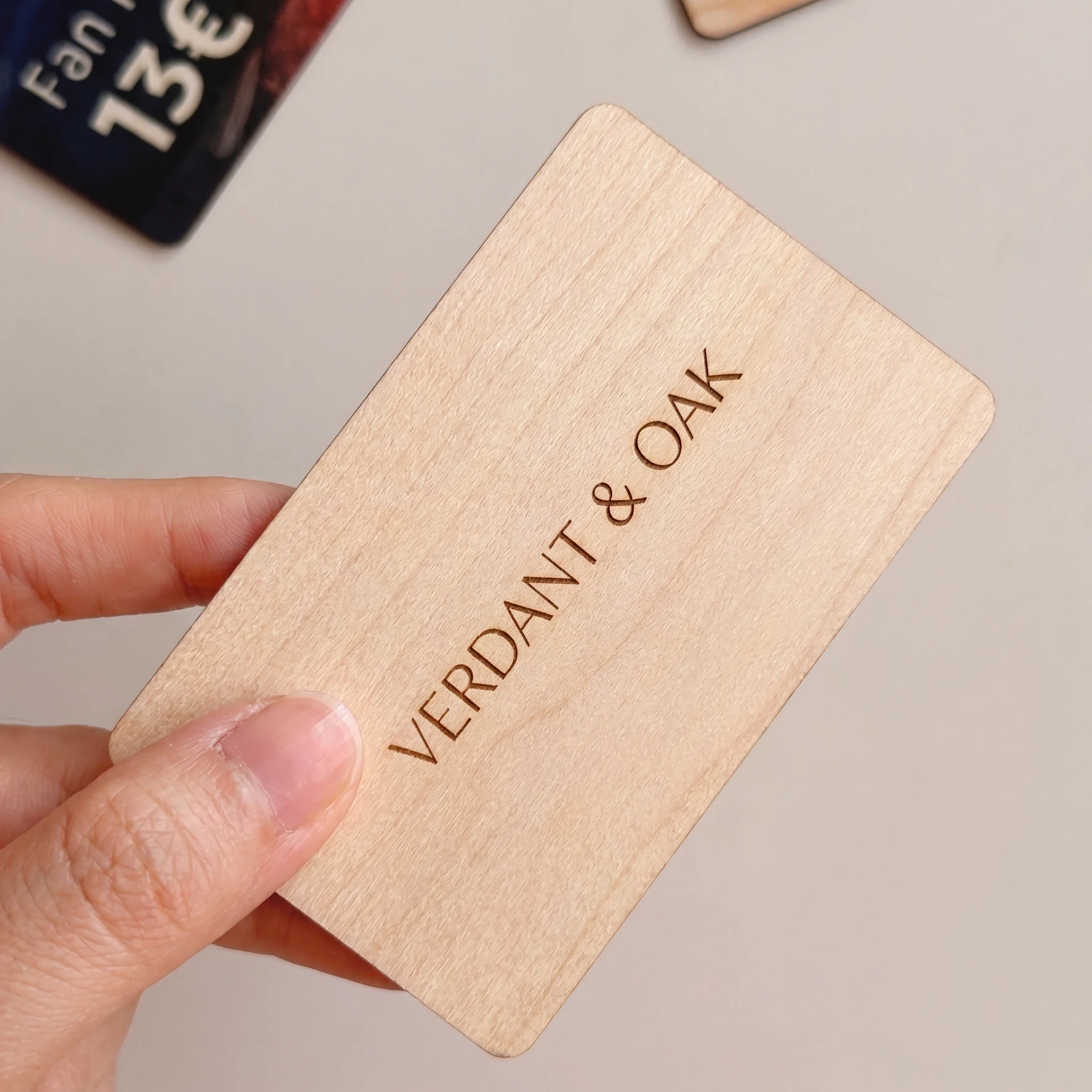 Laser engraved wooden key card held in a hand