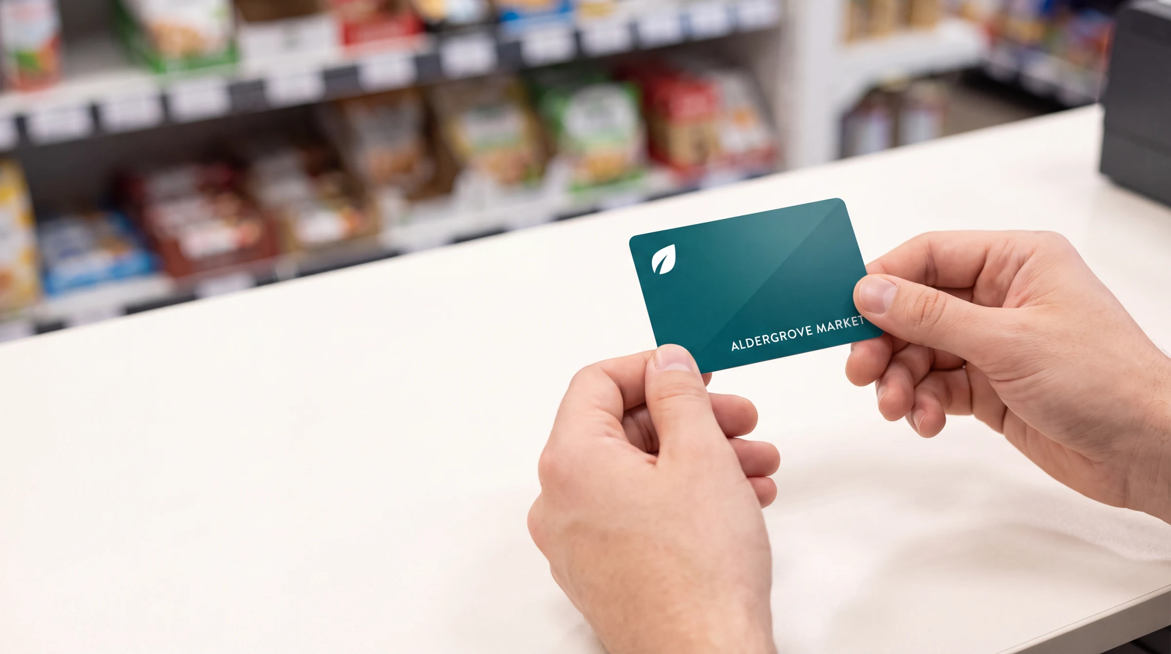 A loyalty card handed over the counter at a shop checkout