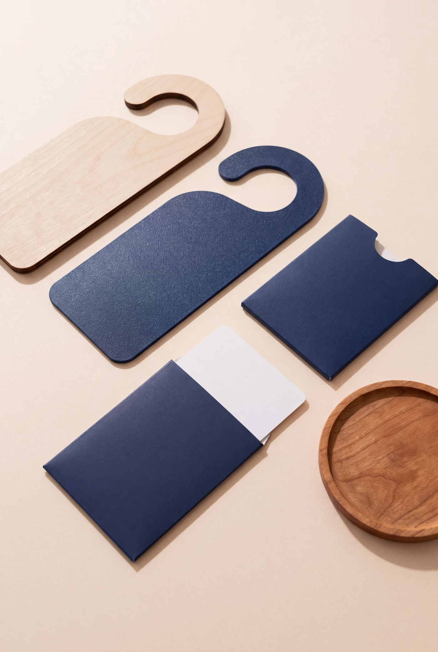 Blank door hangers, wooden coasters, card sleeves and a pen