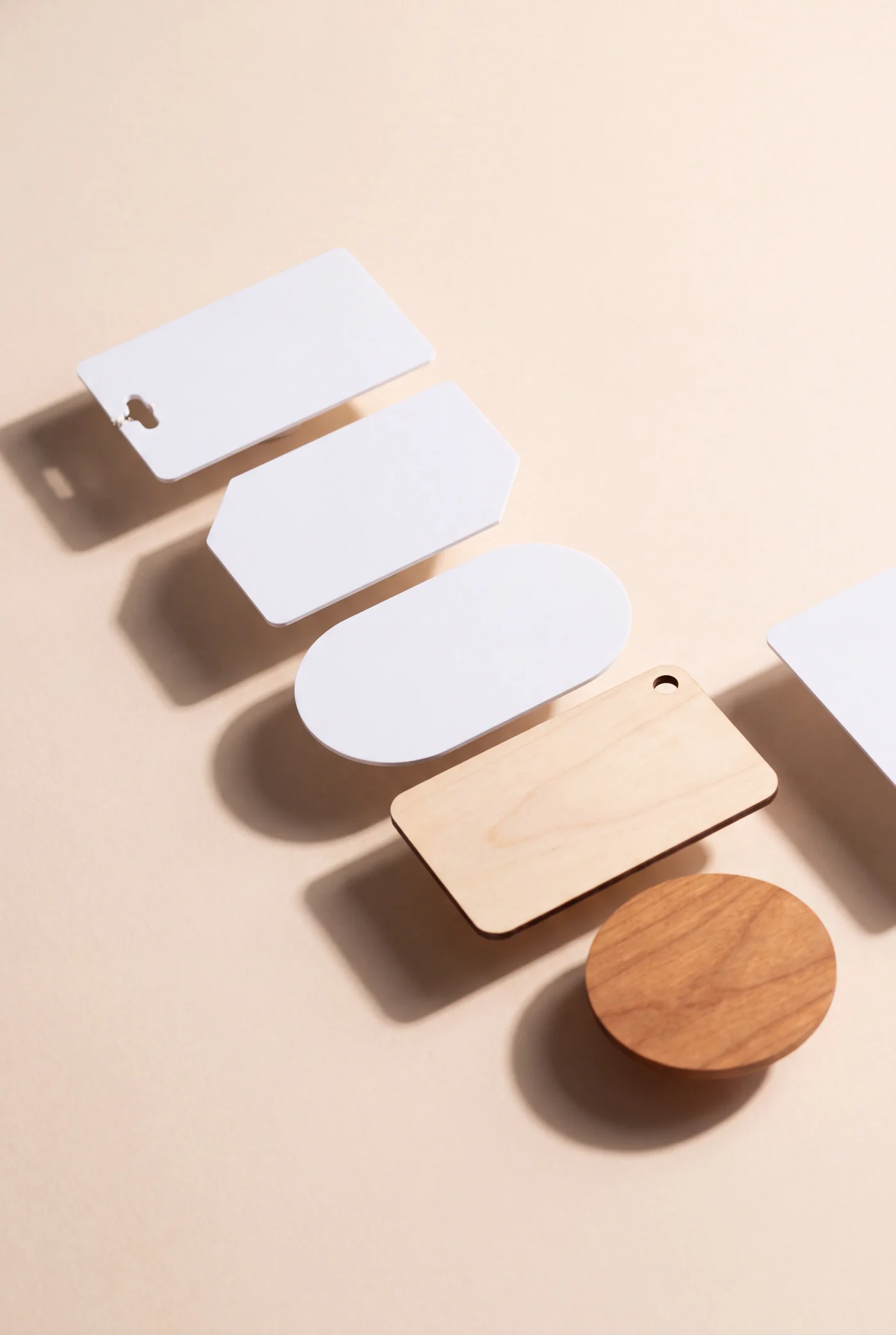 Blank cards that are not rectangles: a punched key tag card, a cut corner card, an oval card, a rounded wooden card and a cherry wood disc