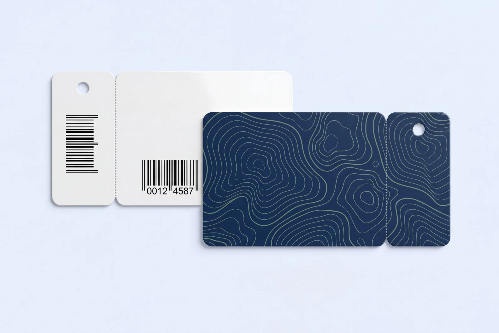 Two combo key tag cards: a navy card with a sage contour line design and its attached key tag, and the white back with a barcode and member number on the card and the tag
