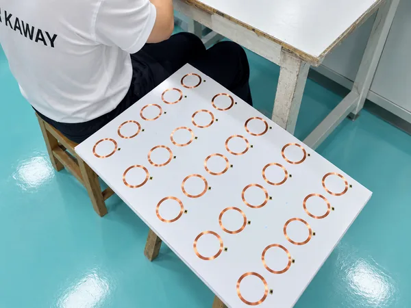 Operator checking a sheet of RFID antennas