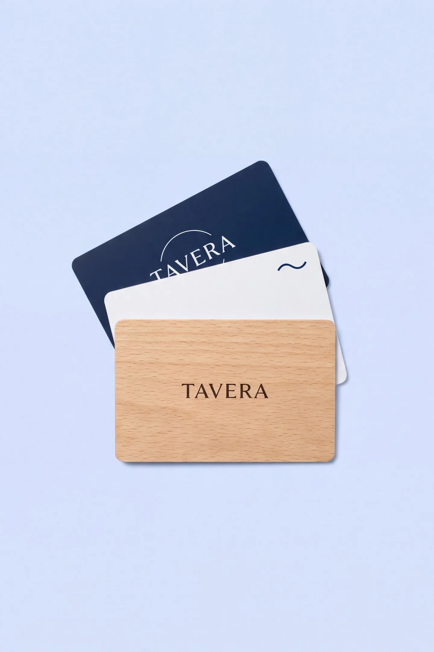Three RFID hotel key cards fanned out: navy PVC, white PVC and light wood, printed TAVERA