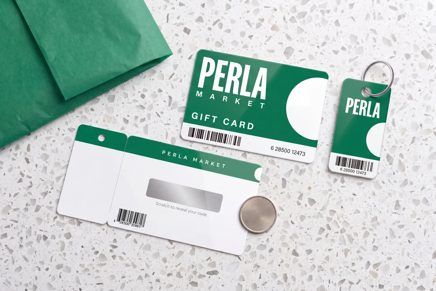 A gift card front, its matching key tag and the card back with the silver scratch panel still covering the code