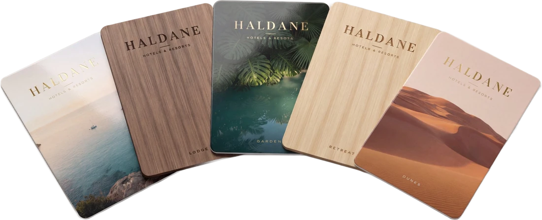 Five key cards for one hotel group: three PVC cards and two wooden cards in black walnut and basswood