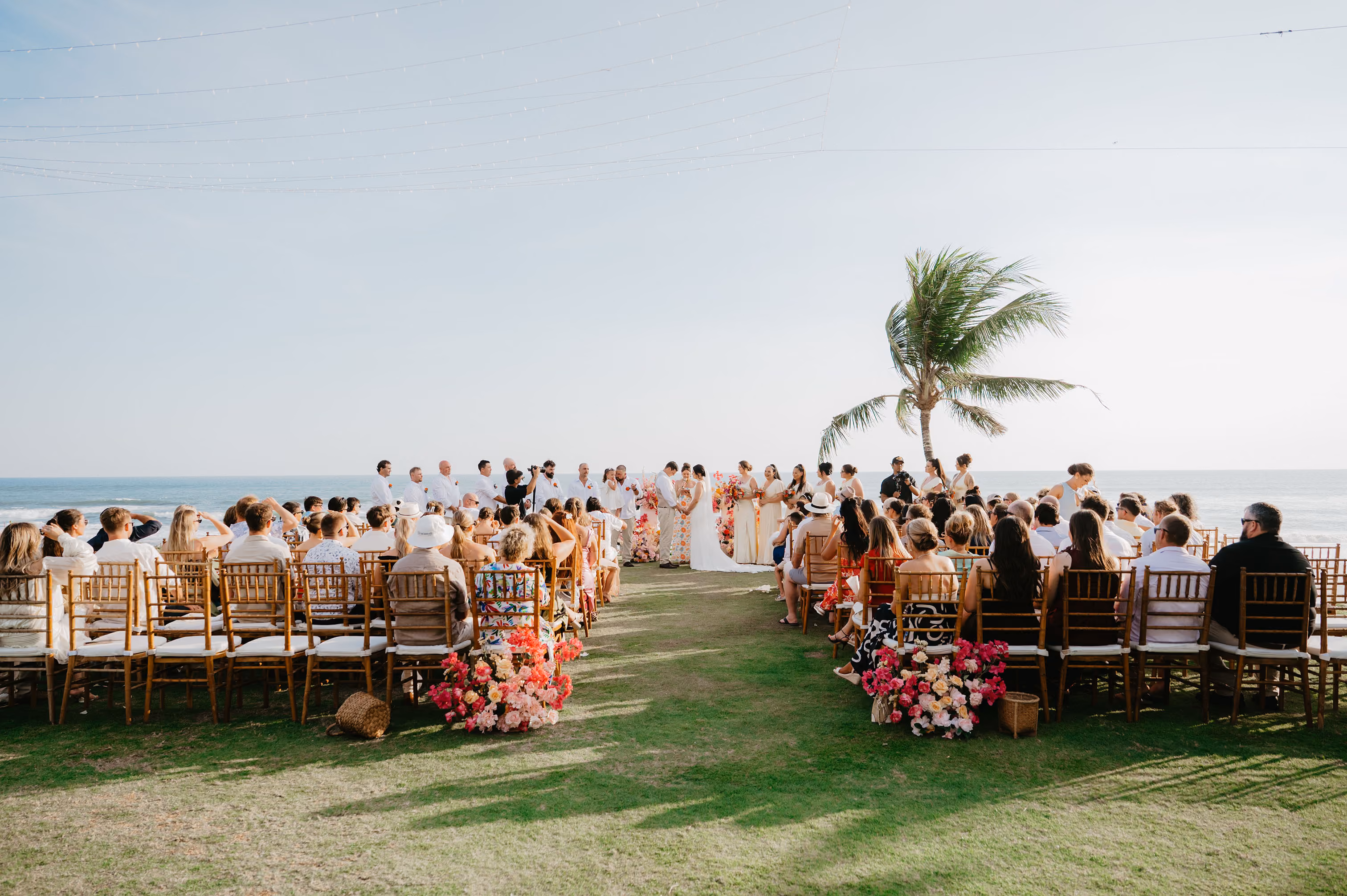 Wedding ceremony with guests seated facing the ocean