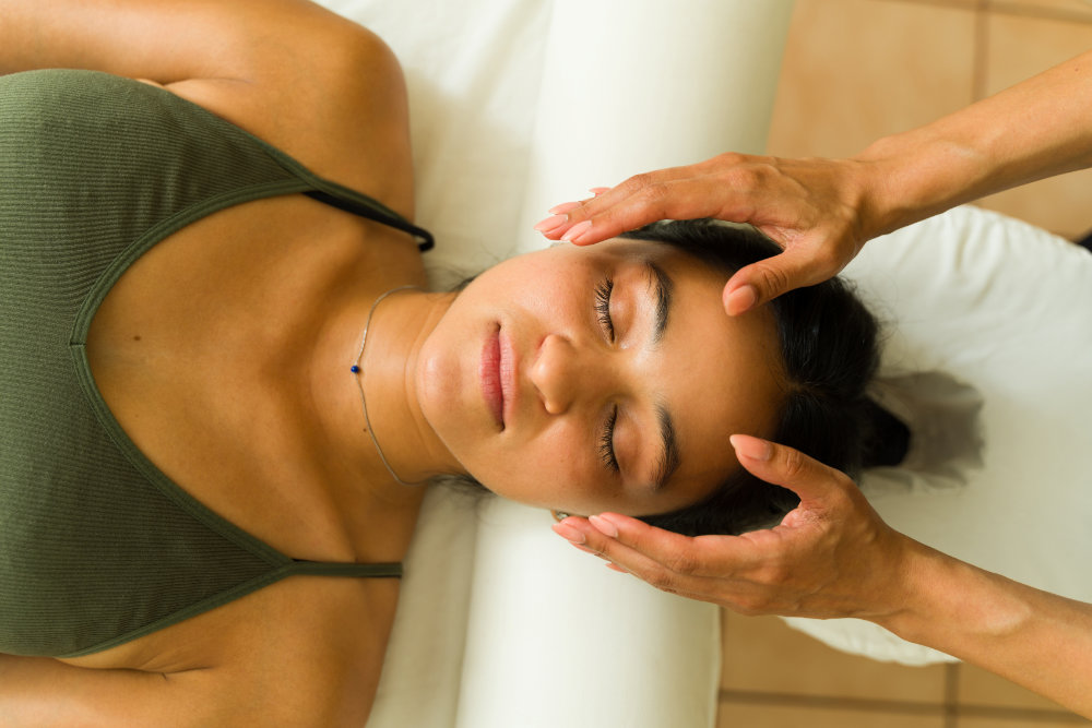 Woman receiving Reiki treatment