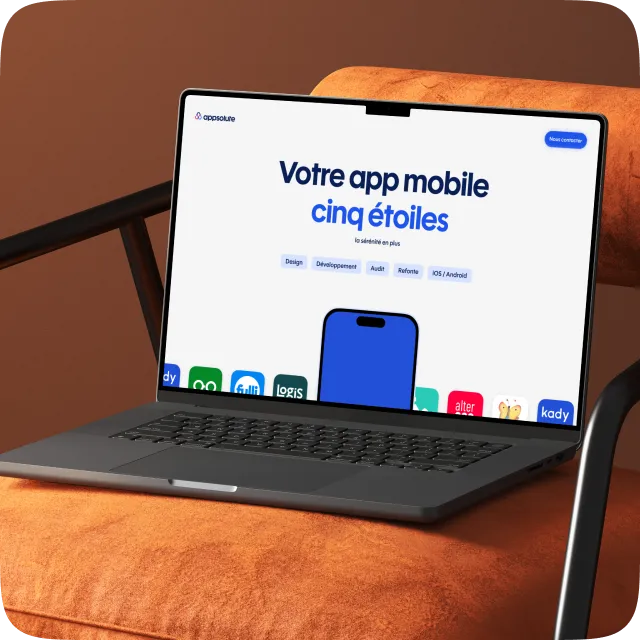 Laptop on an orange cushioned chair displaying a website with French text about a five-star mobile app and app development services.