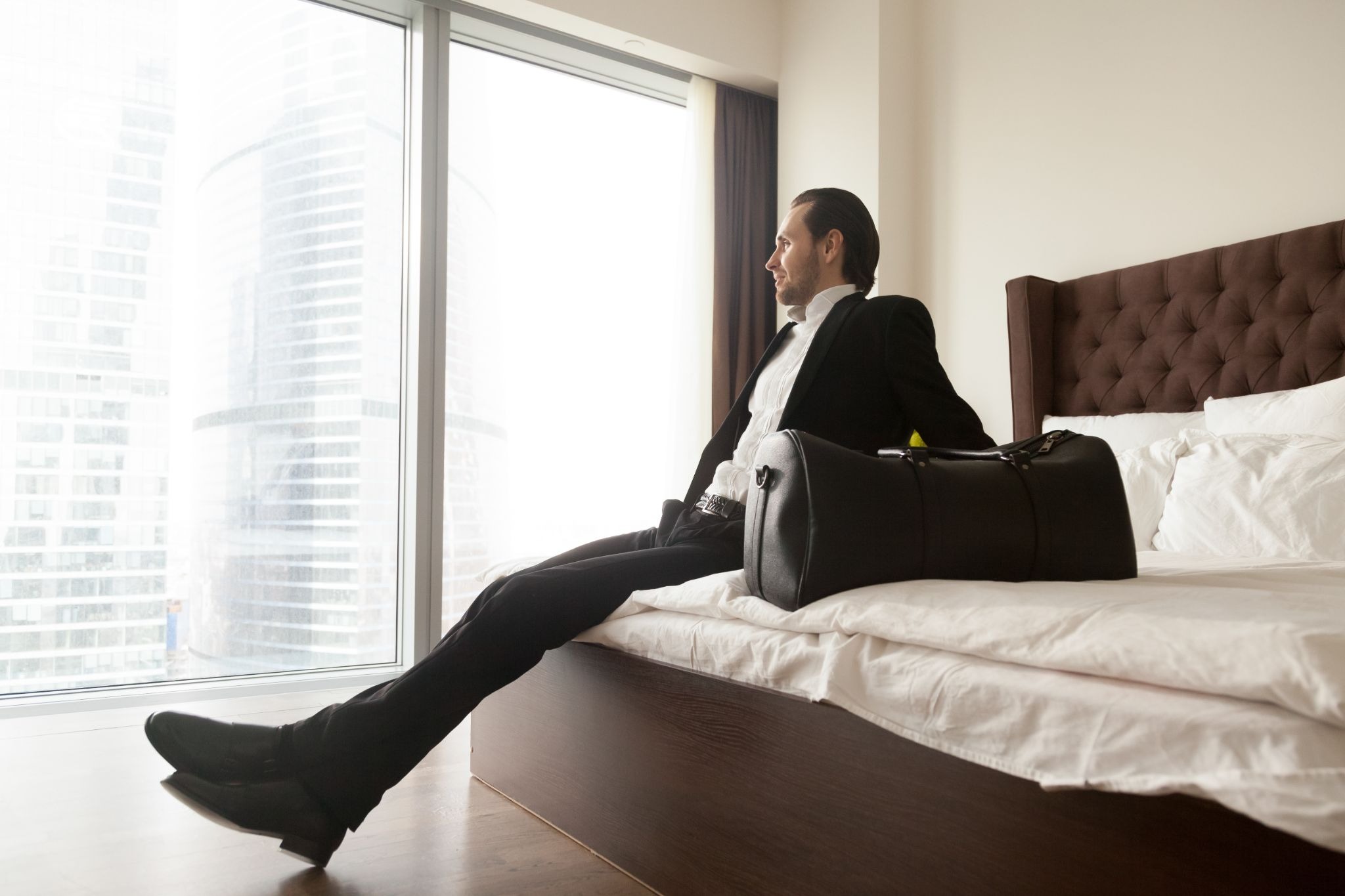 source: https://www.freepik.com/free-photo/relaxed-businessman-sitting-bed-besides-luggage-bag_4013386.htm#fromView=search&page=7&position=43&uuid=f0b87b96-4f0f-4ac0-9f19-8913720f68a0&query=black+woman+hotelroom