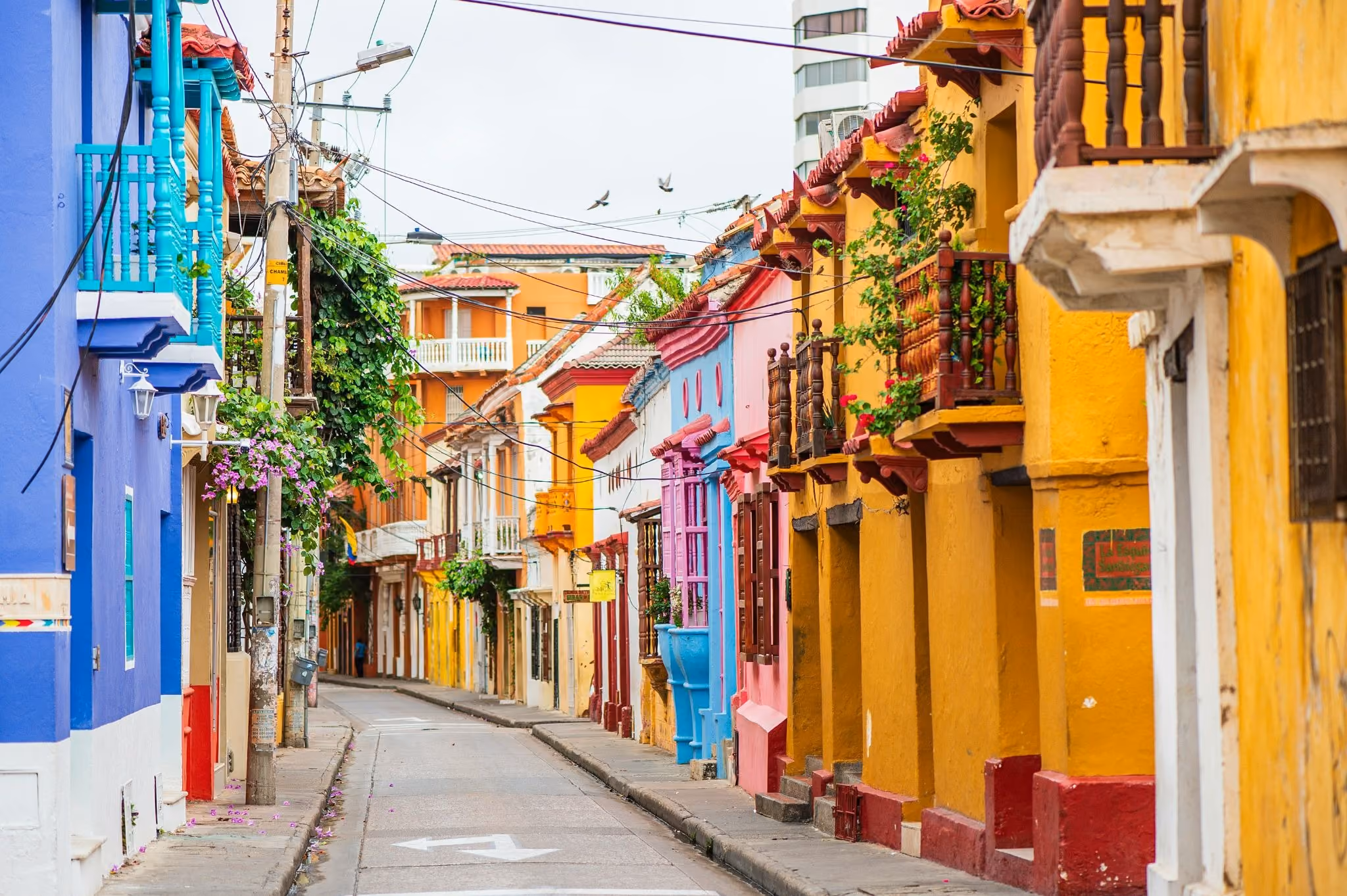 source: https://unsplash.com/photos/a-narrow-city-street-lined-with-colorful-buildings-acH94SHbWS4