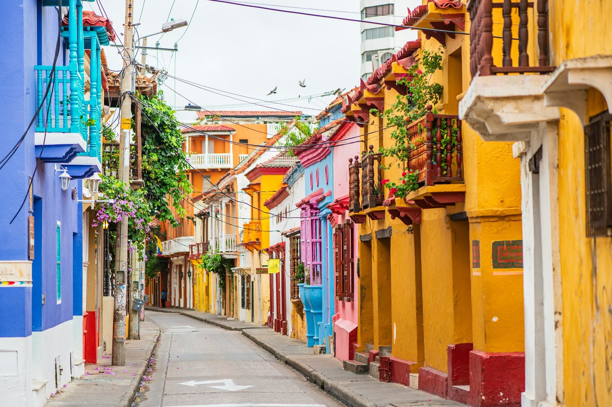 source: https://unsplash.com/photos/a-narrow-city-street-lined-with-colorful-buildings-acH94SHbWS4