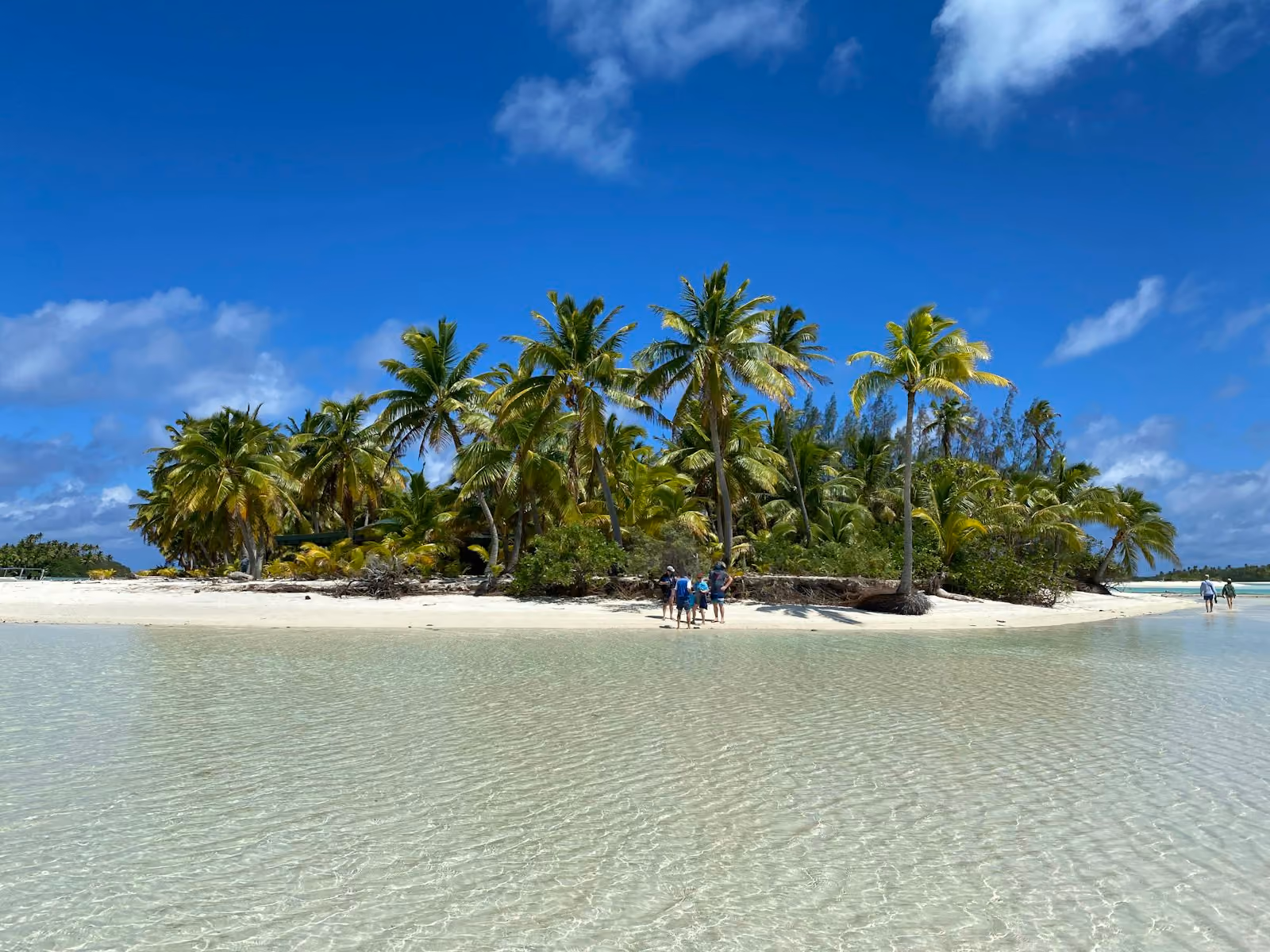 Traveller walking a sandy beach path in Rarotonga during the dry season