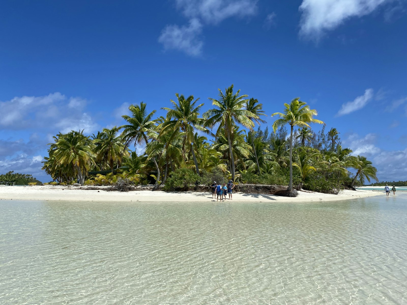 Traveller walking a sandy beach path in Rarotonga during the dry season